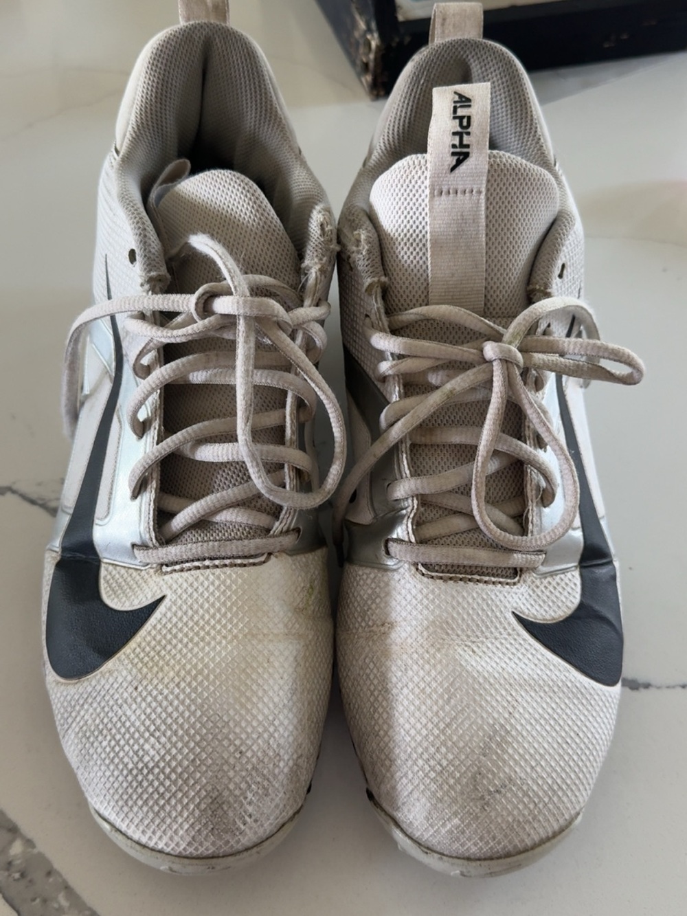 Alpha Nike cleats in Light White with Black Swoosh